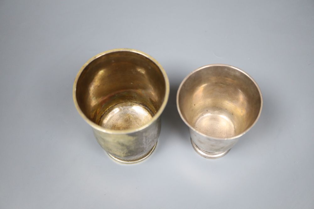An 18th century French white metal beaker, 94mm and a later gilt white metal French beaker, 11.3cm, gross 7.5oz.